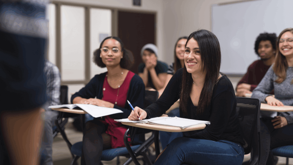 Female learners in the classroom, sitting down at desks