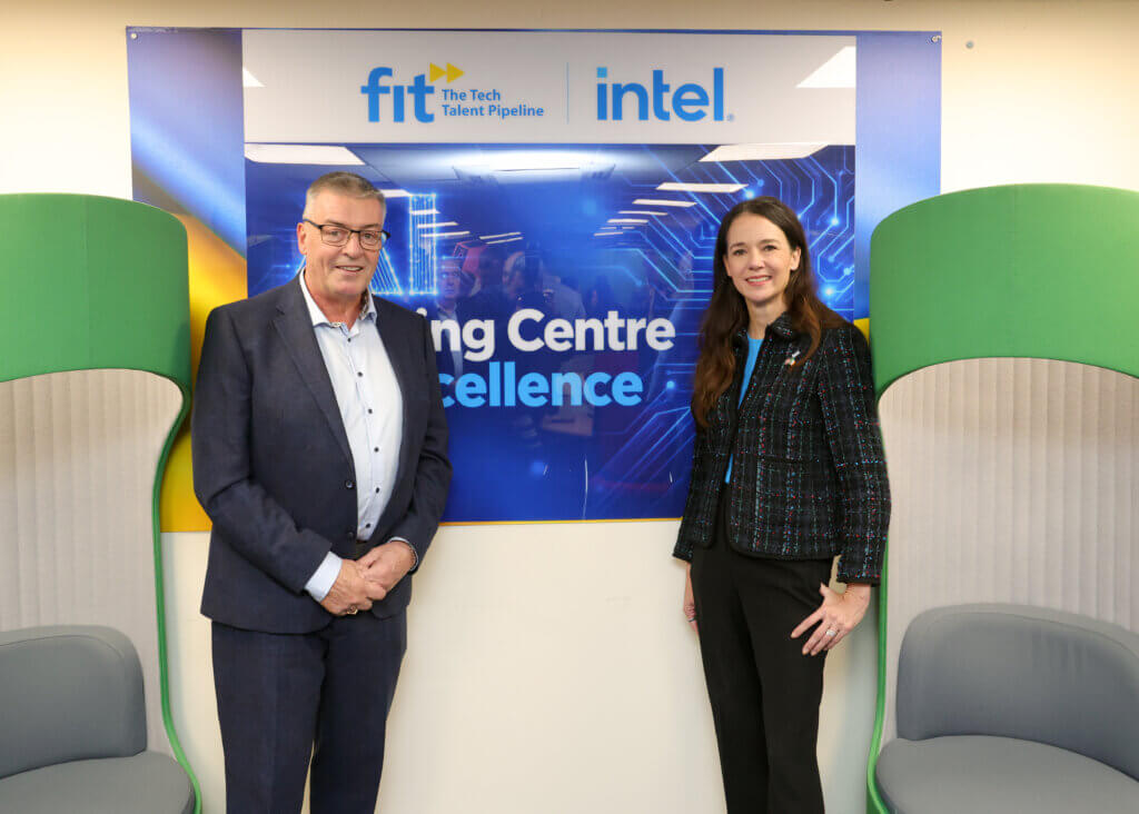 man and woman standing infront of a sign that says AI Training Centre of Excellence