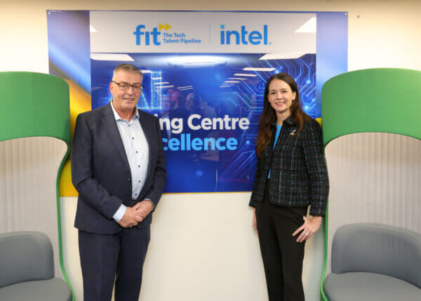 man and woman standing infront of a sign that says AI Training Centre of Excellence